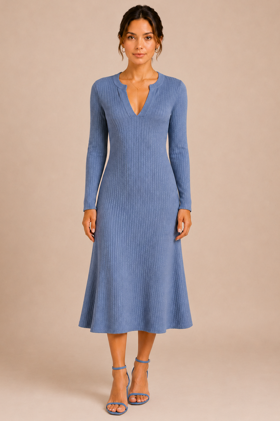 Woman wearing a blue ribbed dress against a beige background
